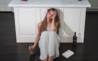 woman in black and white stripe dress holding wine glass