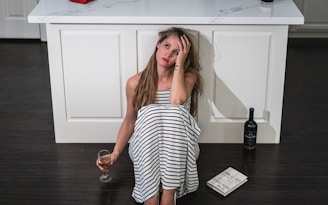 woman in black and white stripe dress holding wine glass