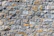 Close-up of a meticulously crafted stone wall showcasing texture and precision in natural light.