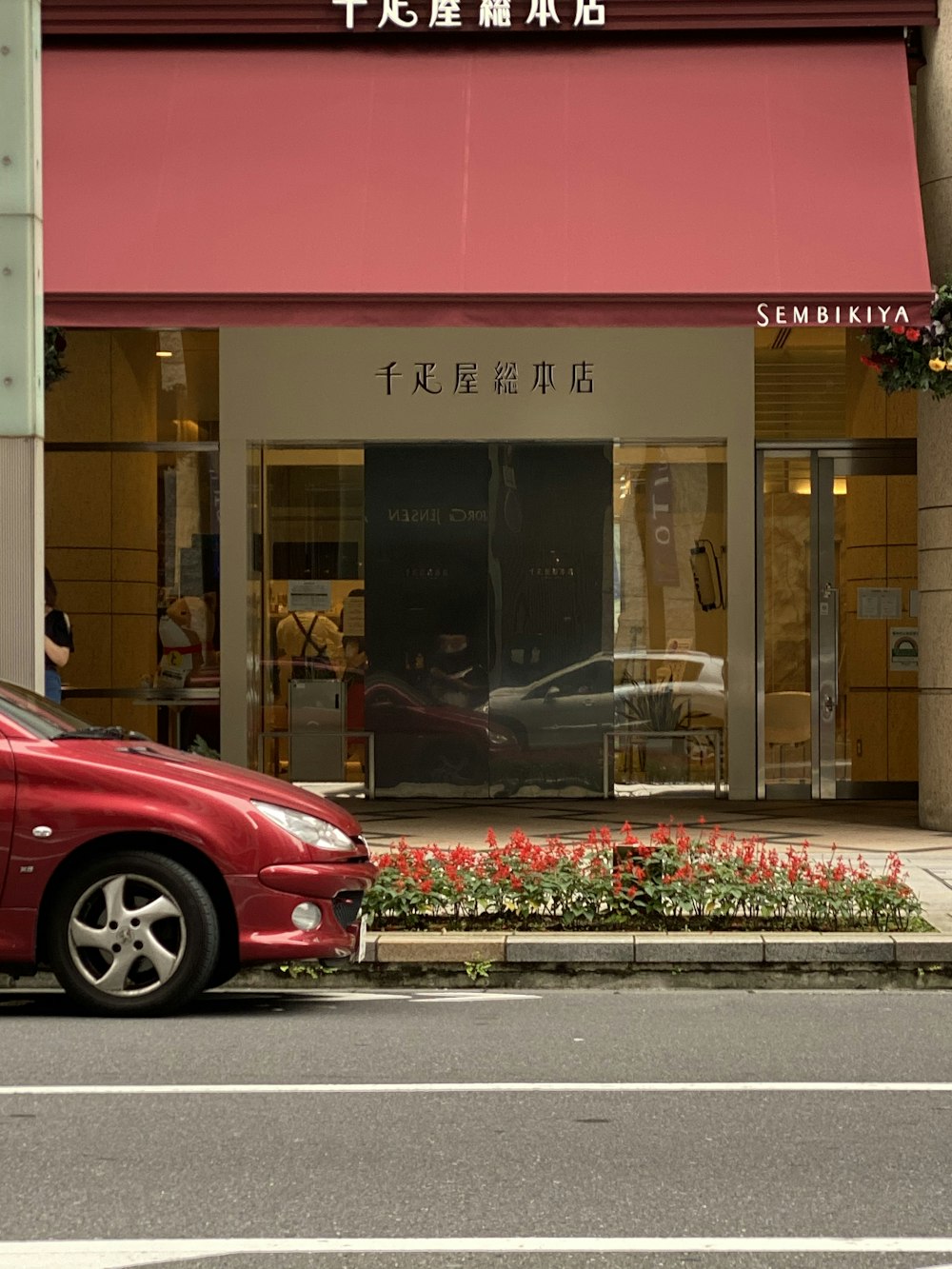 red car parked in front of UNKs restaurant