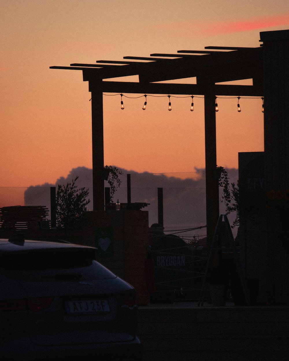 black car on road during sunset