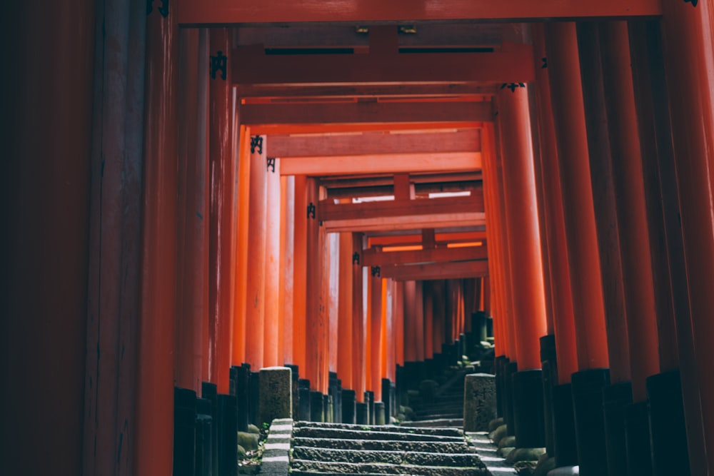 brown wooden staircase with orange curtain