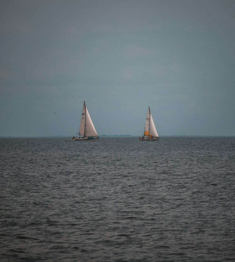 white sail boat on sea during daytime