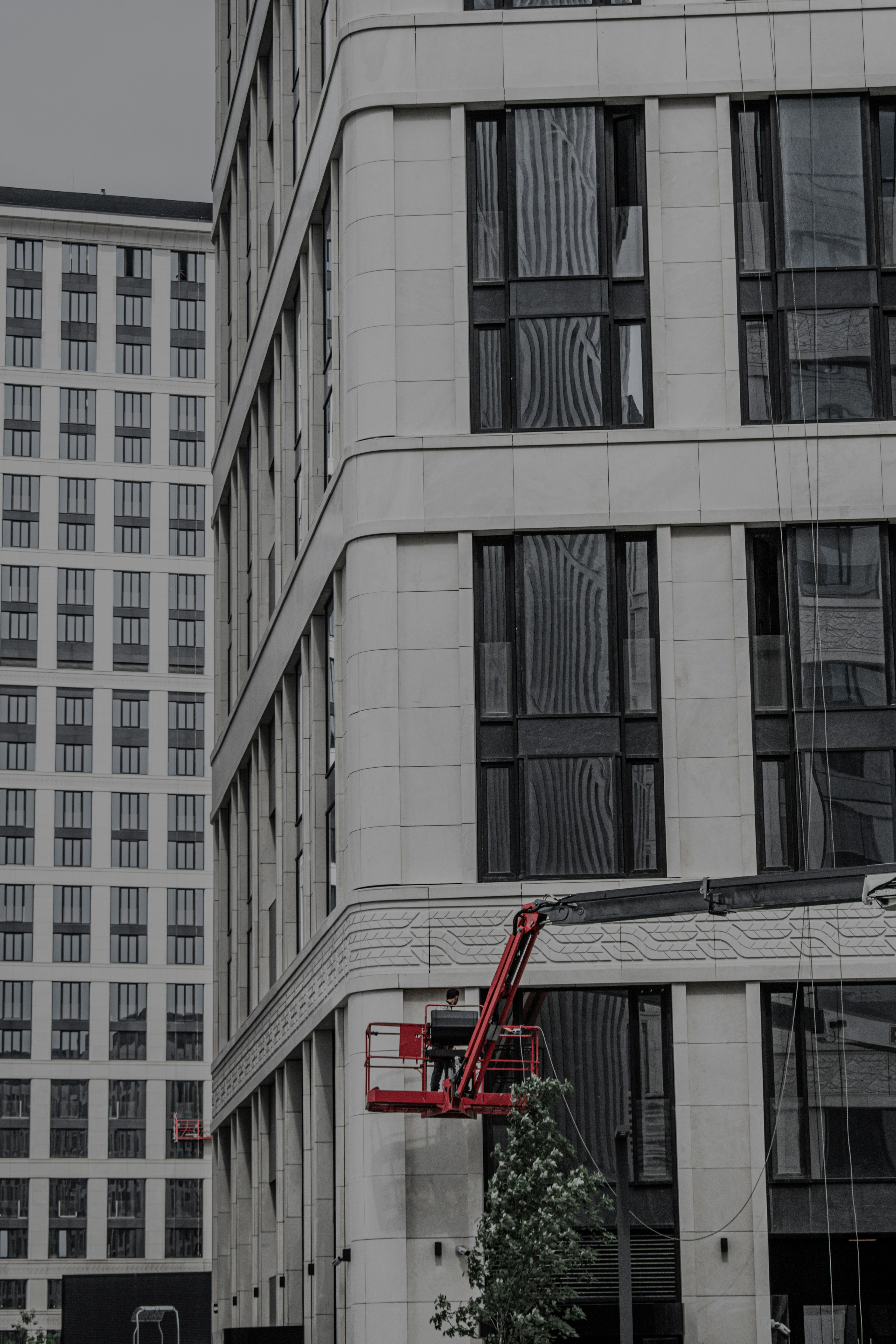 red fire truck parked beside white concrete building