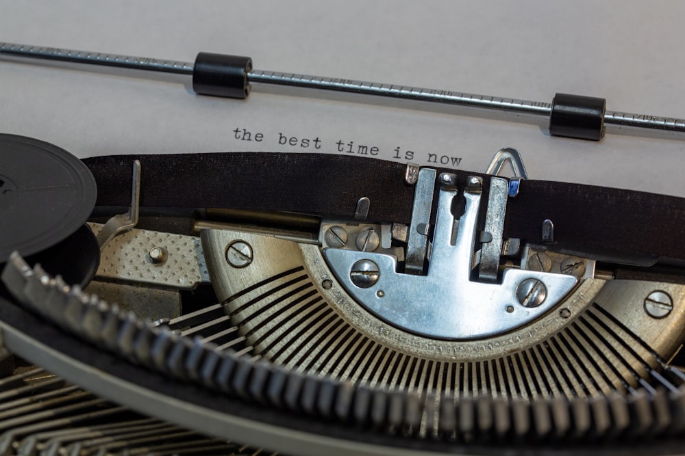 black and gray typewriter on white table