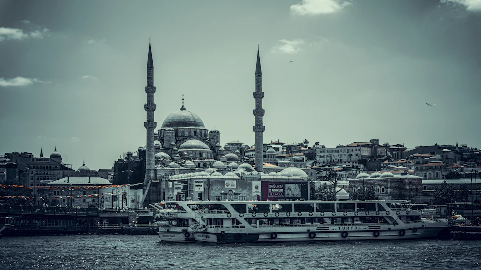 Two large white domed buildings with blue roofs and tall minarets dominate Bosphorus strait landscape
