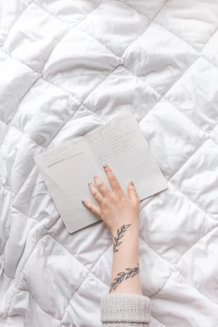 Close-up of hands gently holding a notebook with heartfelt handwritten notes.