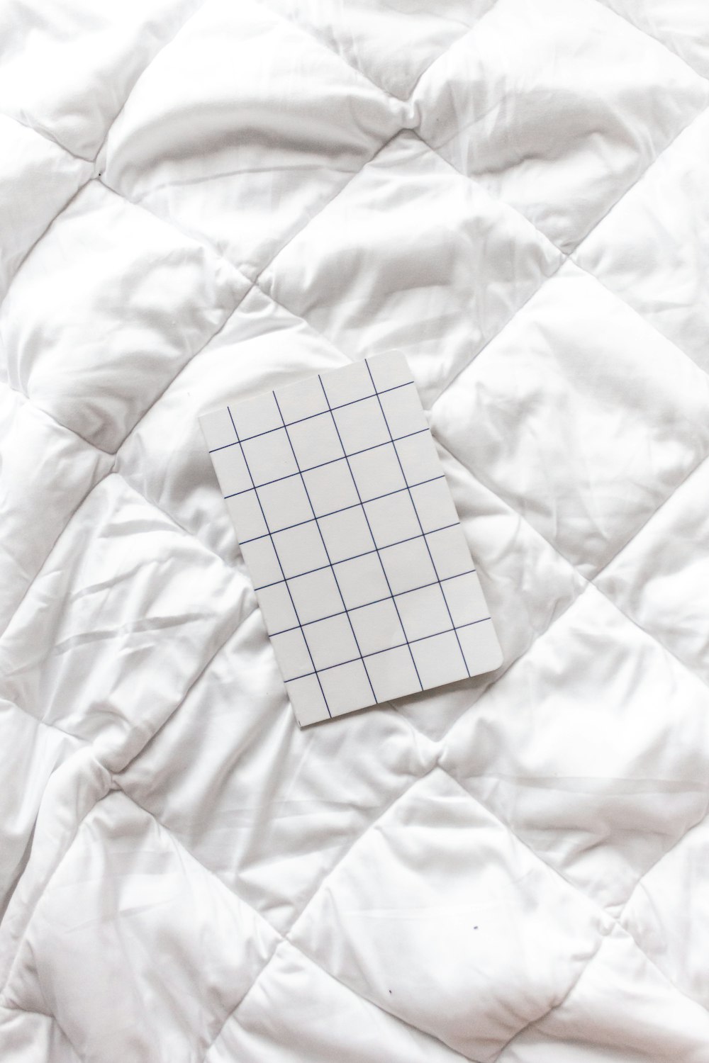white and black checkered paper on white textile