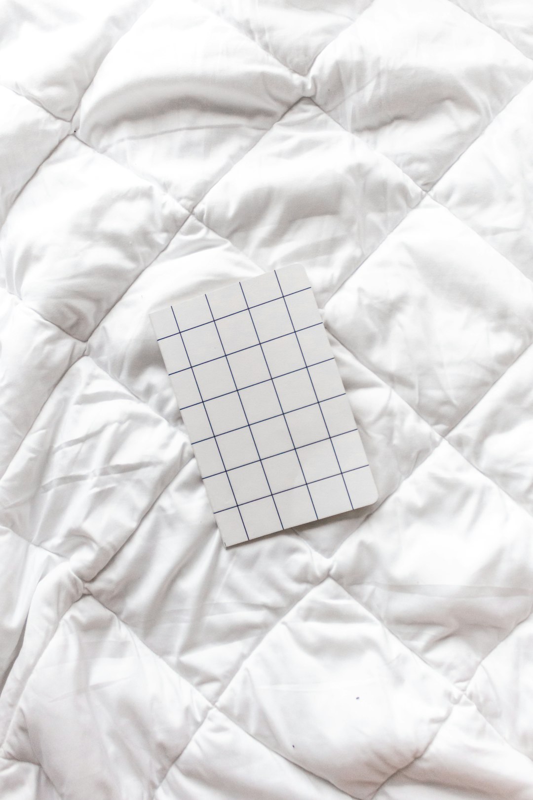  white and black checkered paper on white textile quilt