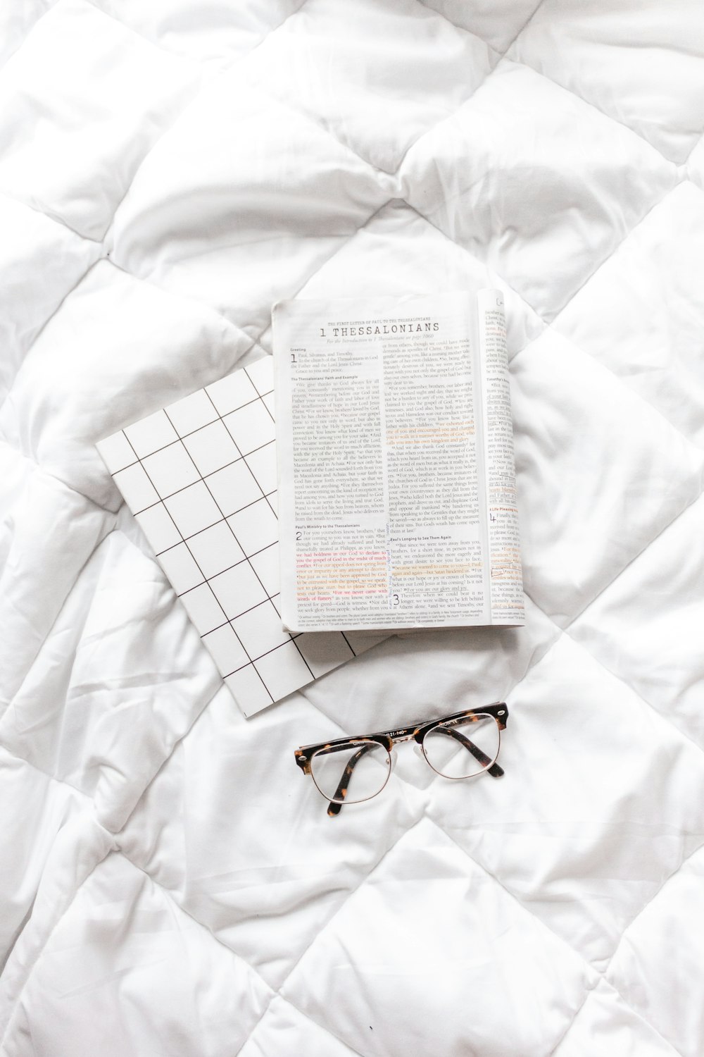 black framed eyeglasses on white textile