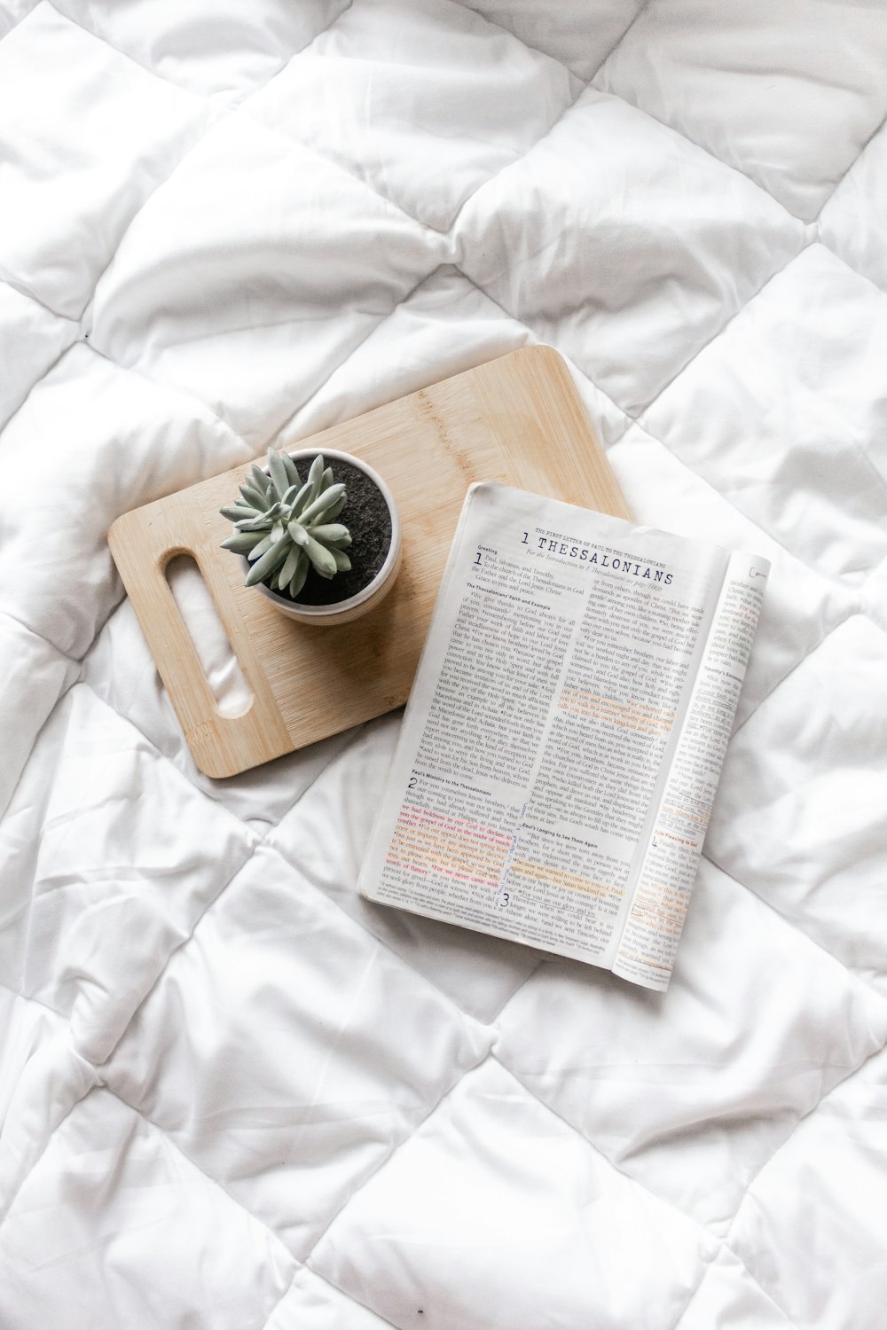 white book page on brown wooden chopping board