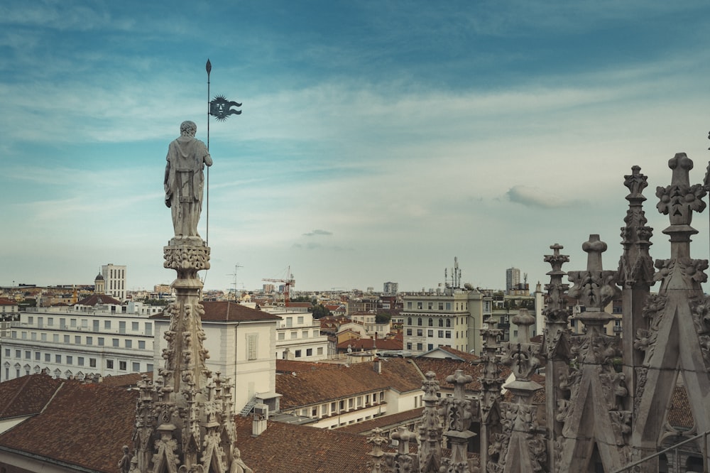 statue of man on top of building