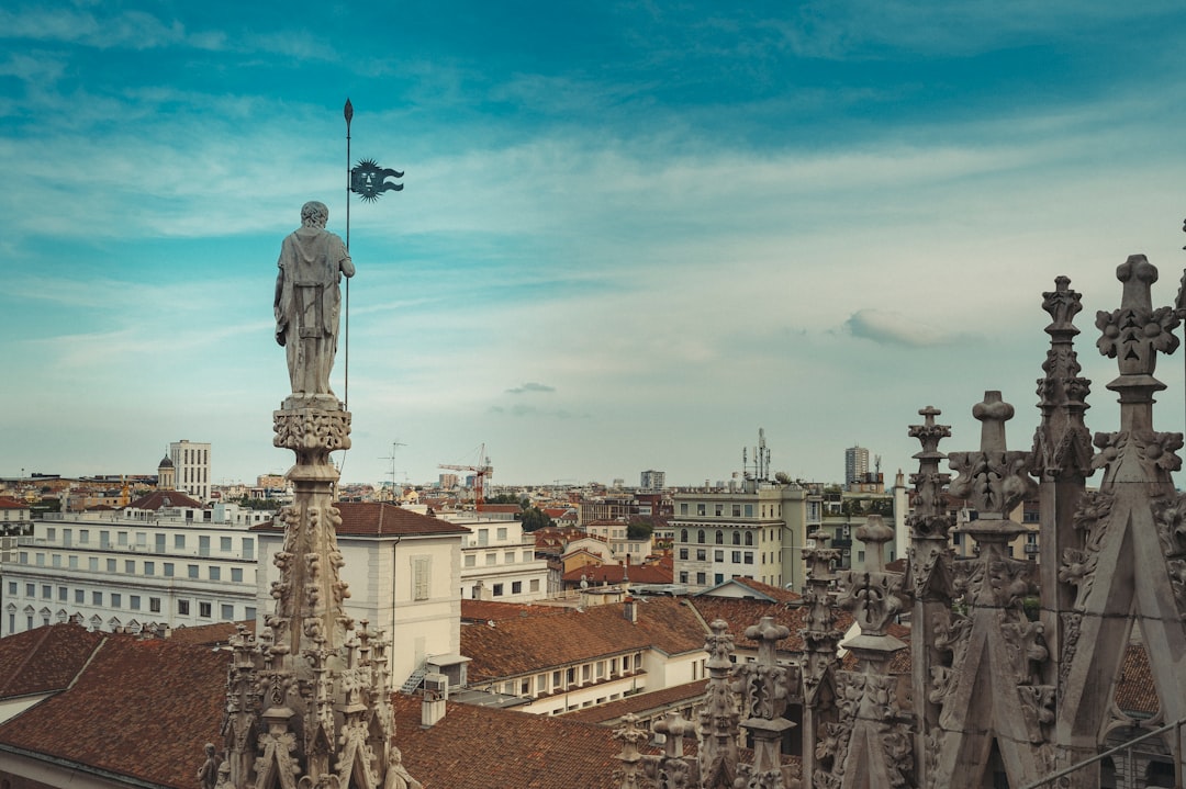 statue of man on top of building