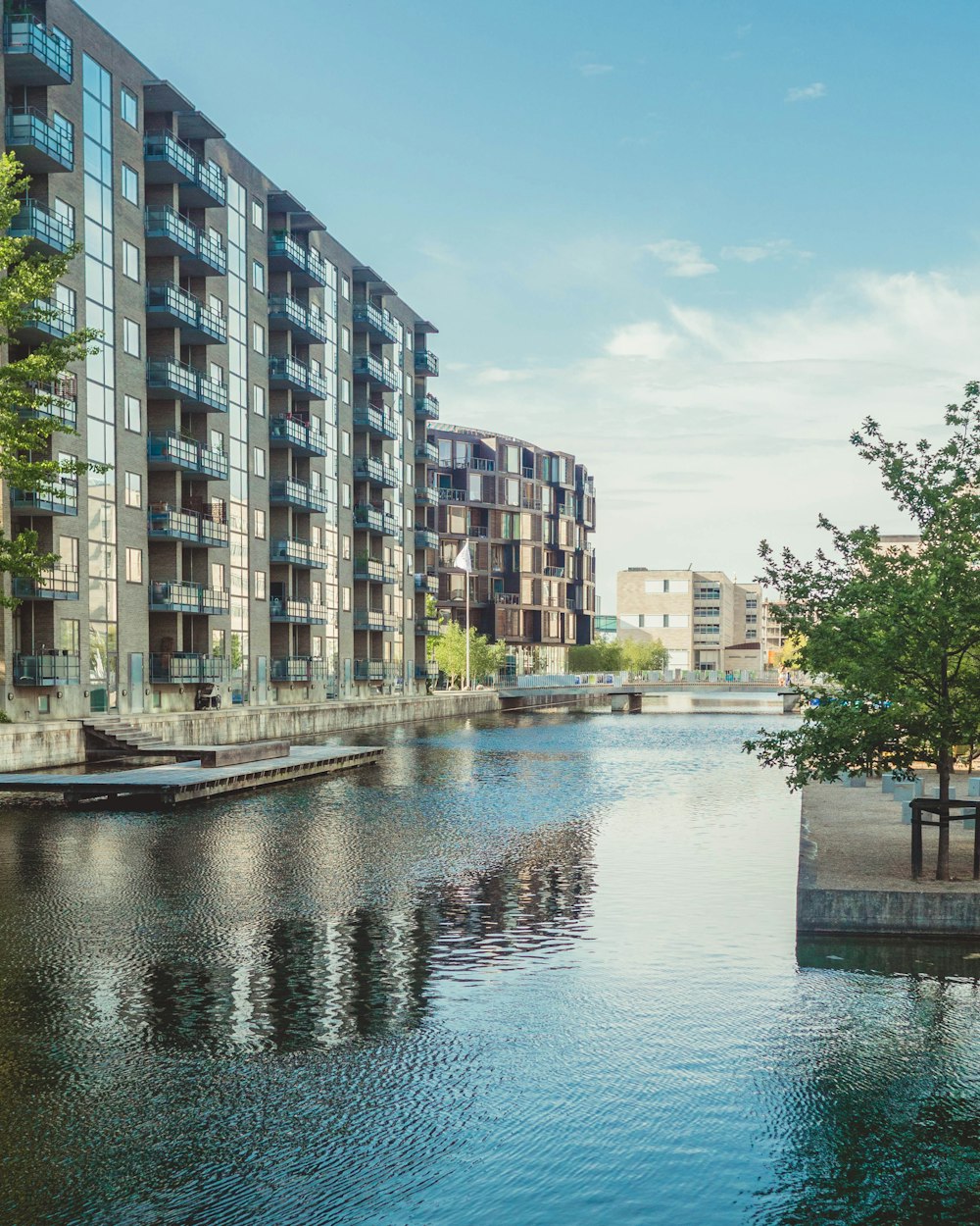 body of water between high rise buildings during daytime