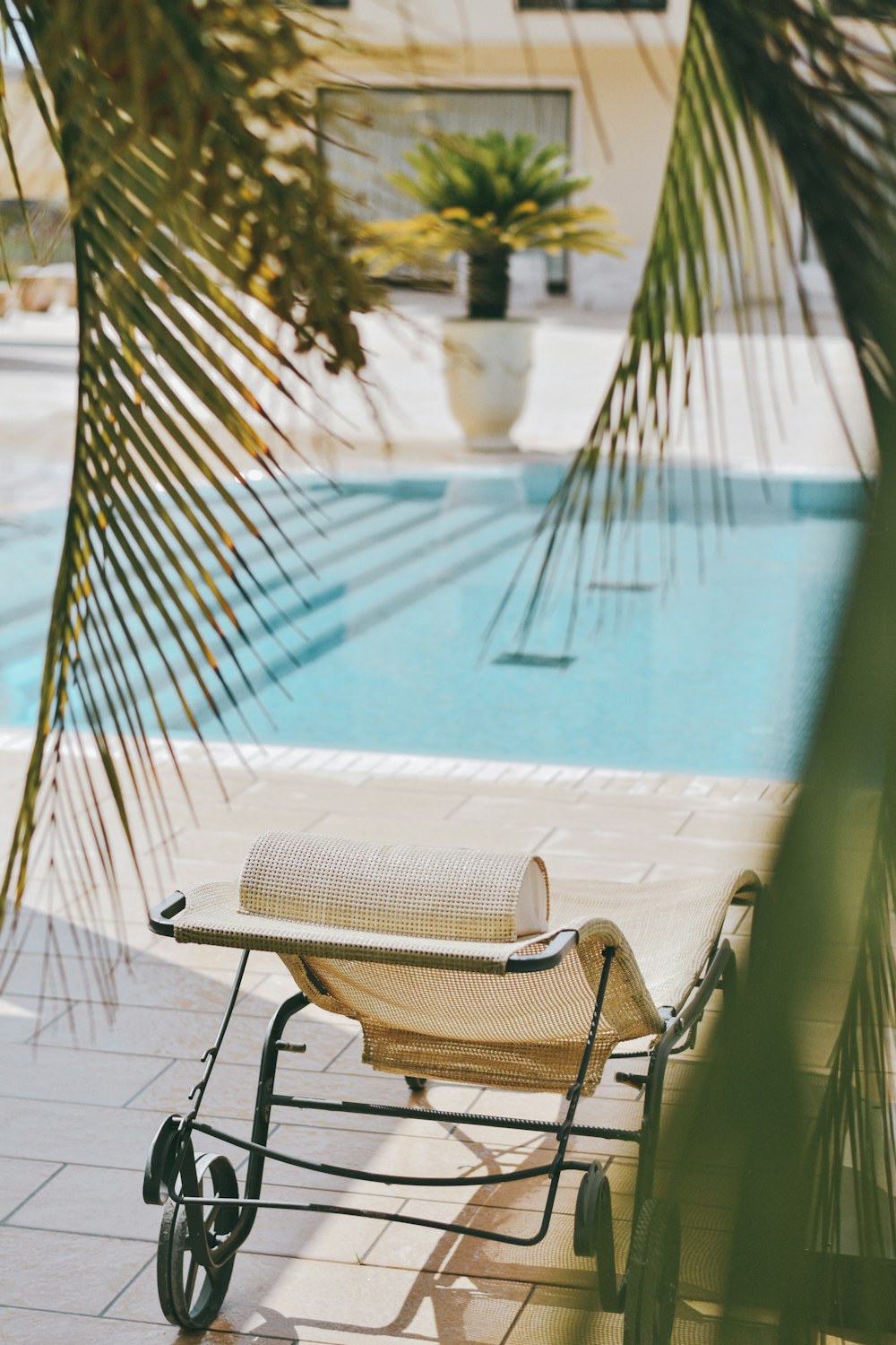 brown and black armchair beside swimming pool during daytime