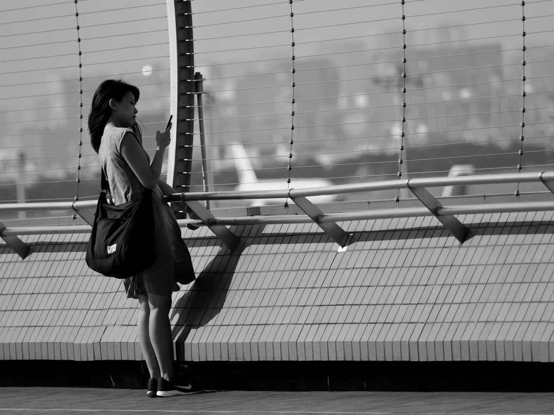 woman in black jacket standing on train station