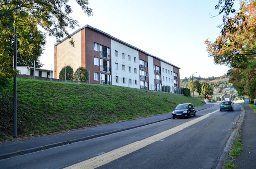 Completed residential building with landscaped surroundings.