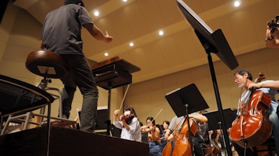 man in black t-shirt playing violin