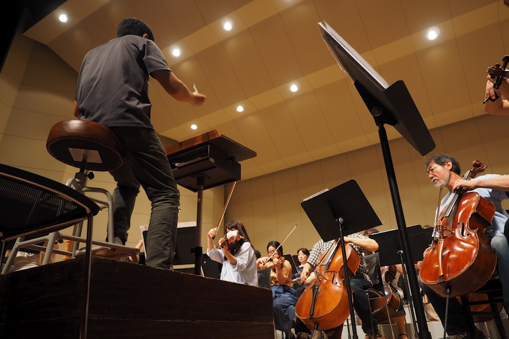 man in black t-shirt playing violin