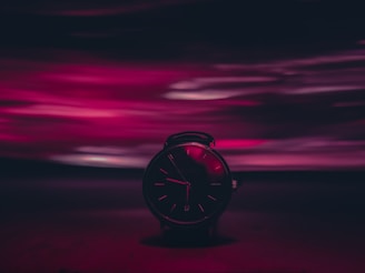 A clock with hands racing against a blurred background symbolizing urgency.