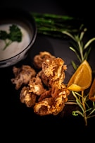 Crispy veg cutlets arranged on a colorful plate with lemon wedges.