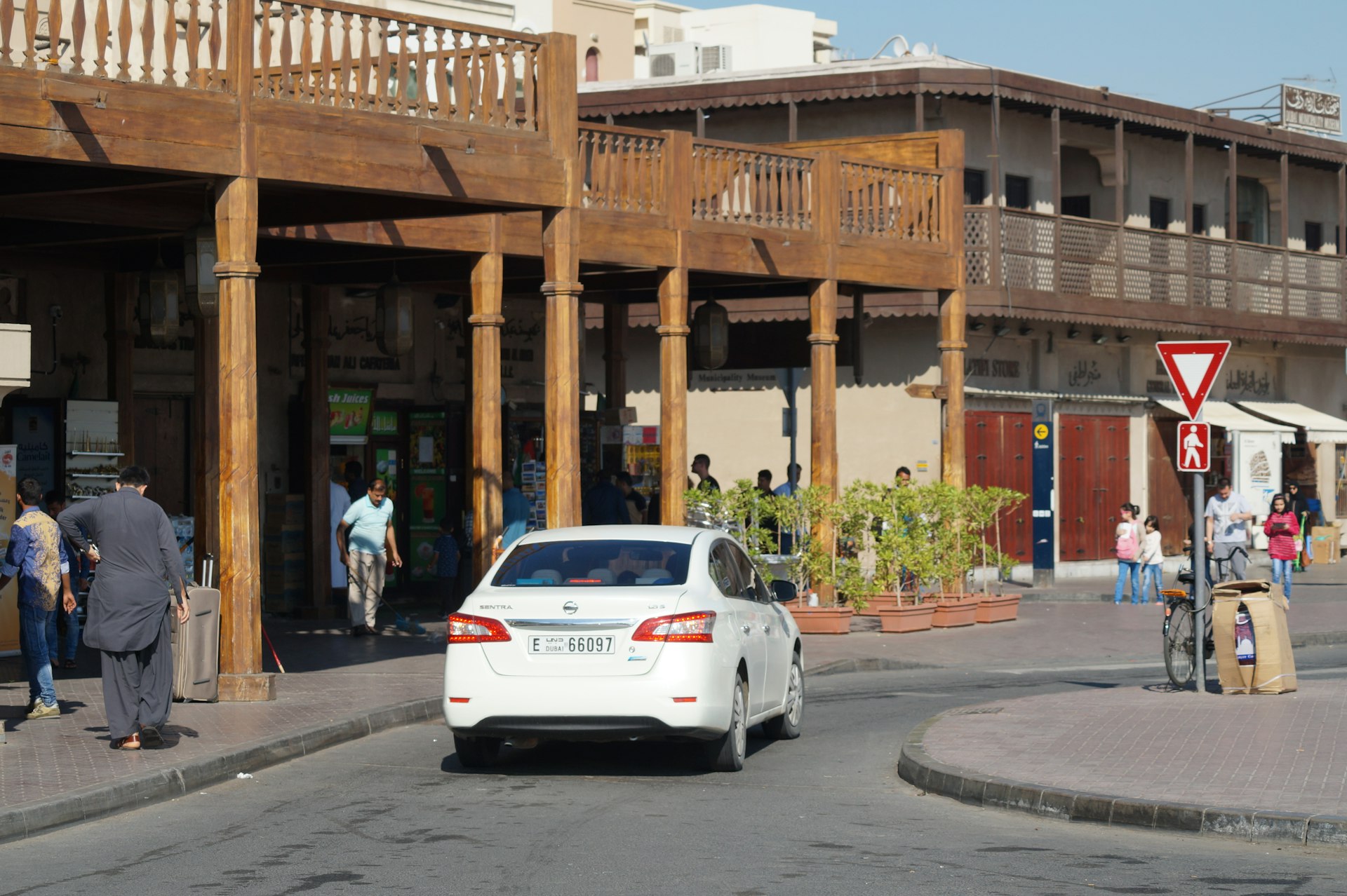 white car parked near brown concrete building during daytime