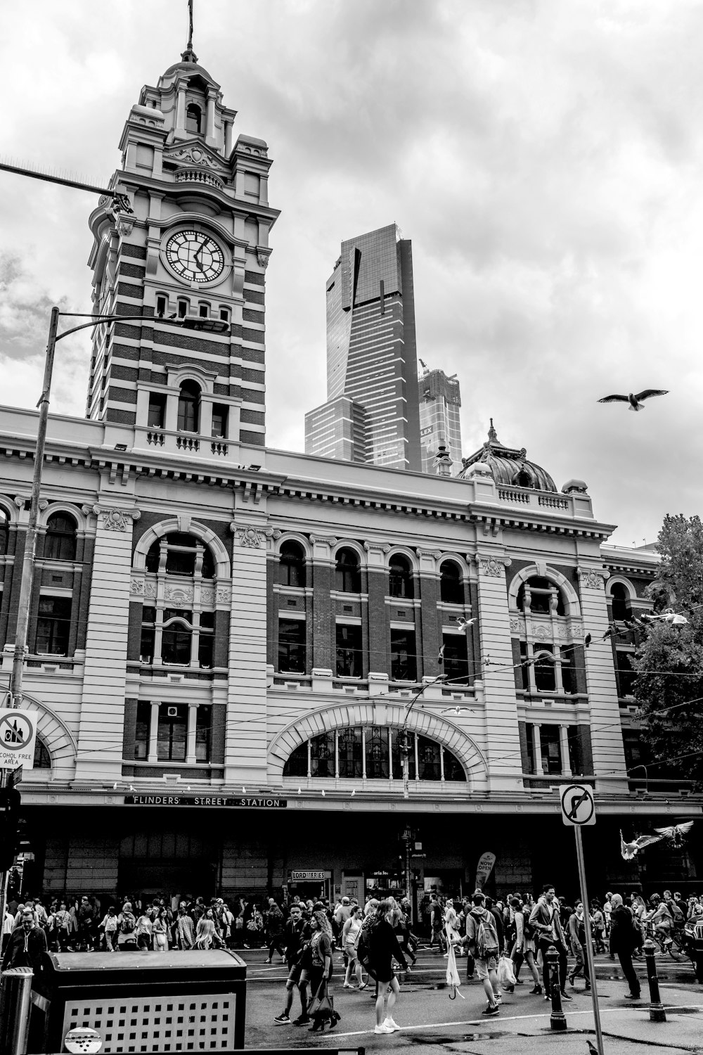 grayscale photo of concrete building with clock