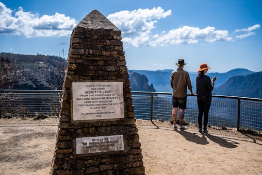man in black jacket standing beside man in black jacket standing near gray concrete tomb during in Govetts Leap lookout Australia