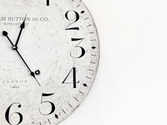 white analog wall clock at 10 00