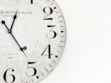 white analog wall clock at 10 00