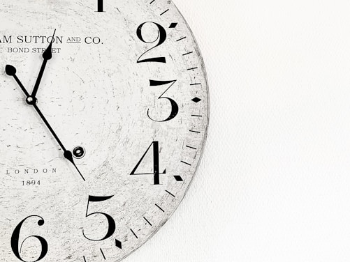 white analog wall clock at 10 00