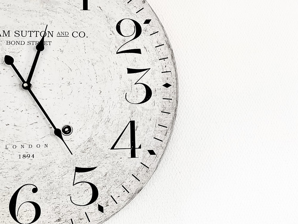 white analog wall clock at 10 00