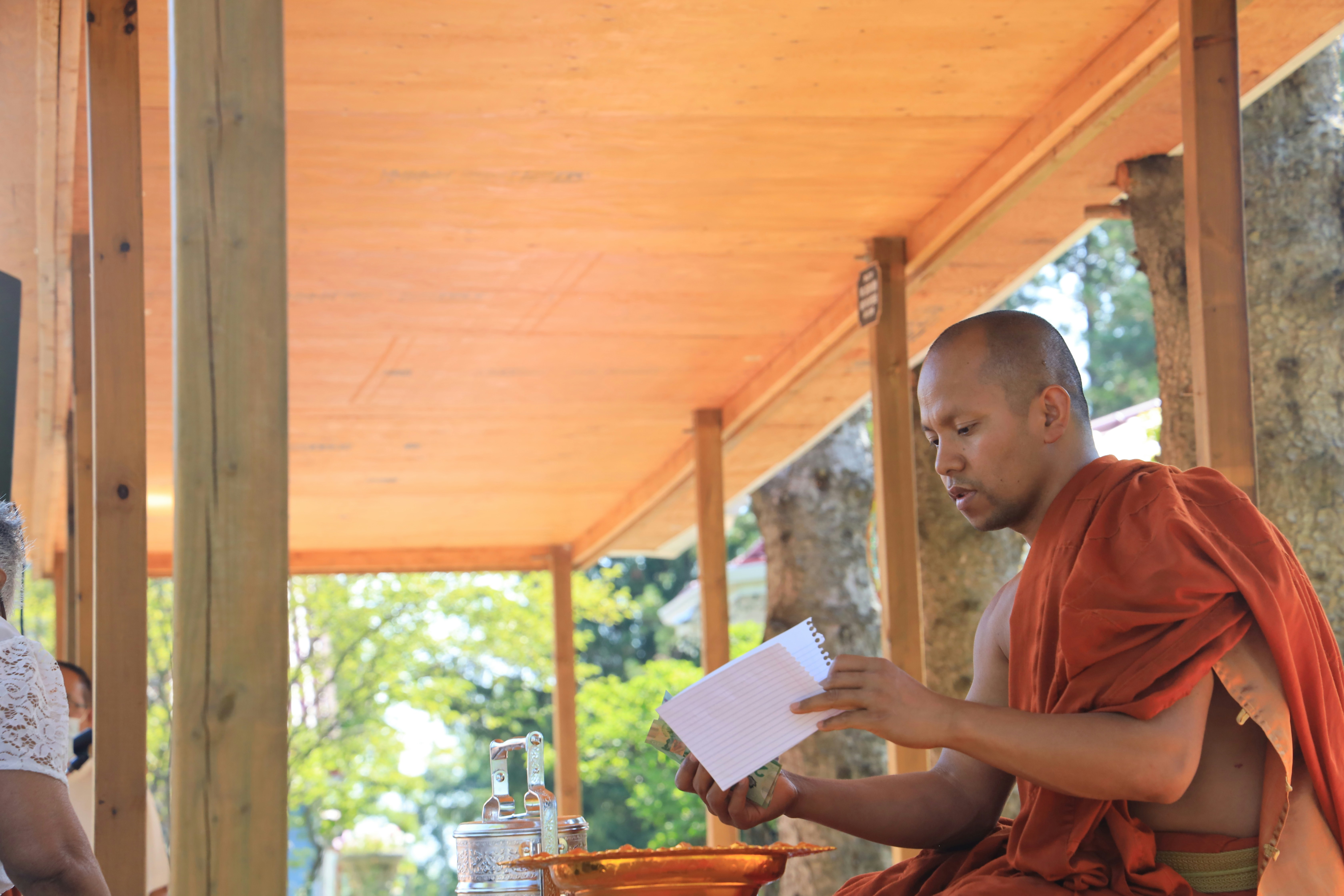 woman in red shirt holding white paper
