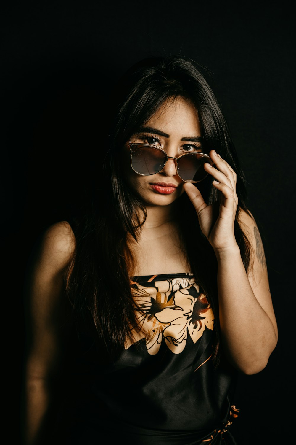 woman in black and white floral tube top wearing brown sunglasses