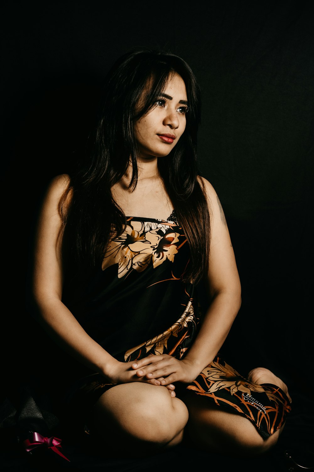 woman in black and brown floral sleeveless dress