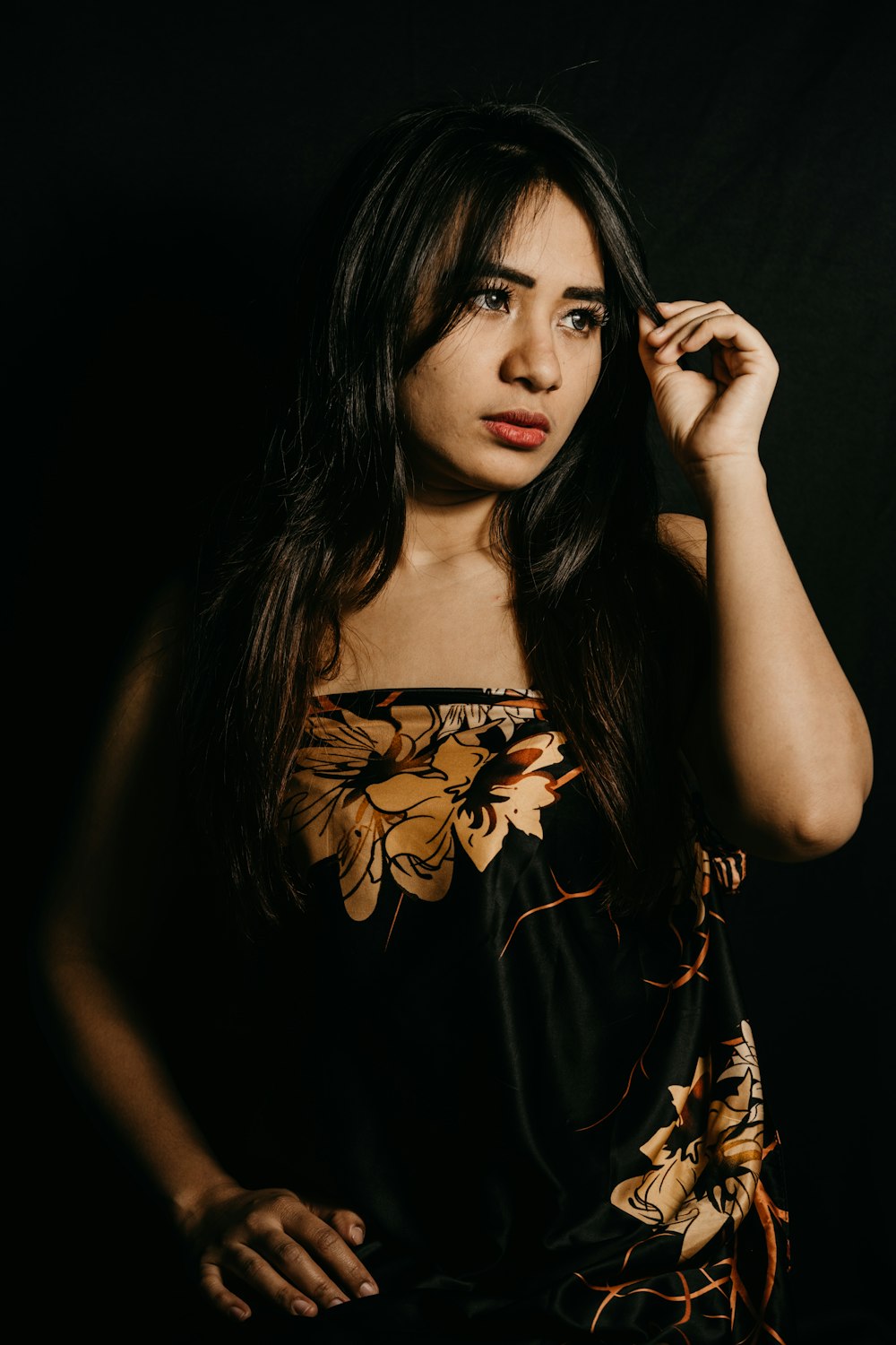 woman in black and brown floral dress