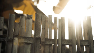 Close-up of sturdy wooden fence panels stacked outdoors in bright daylight