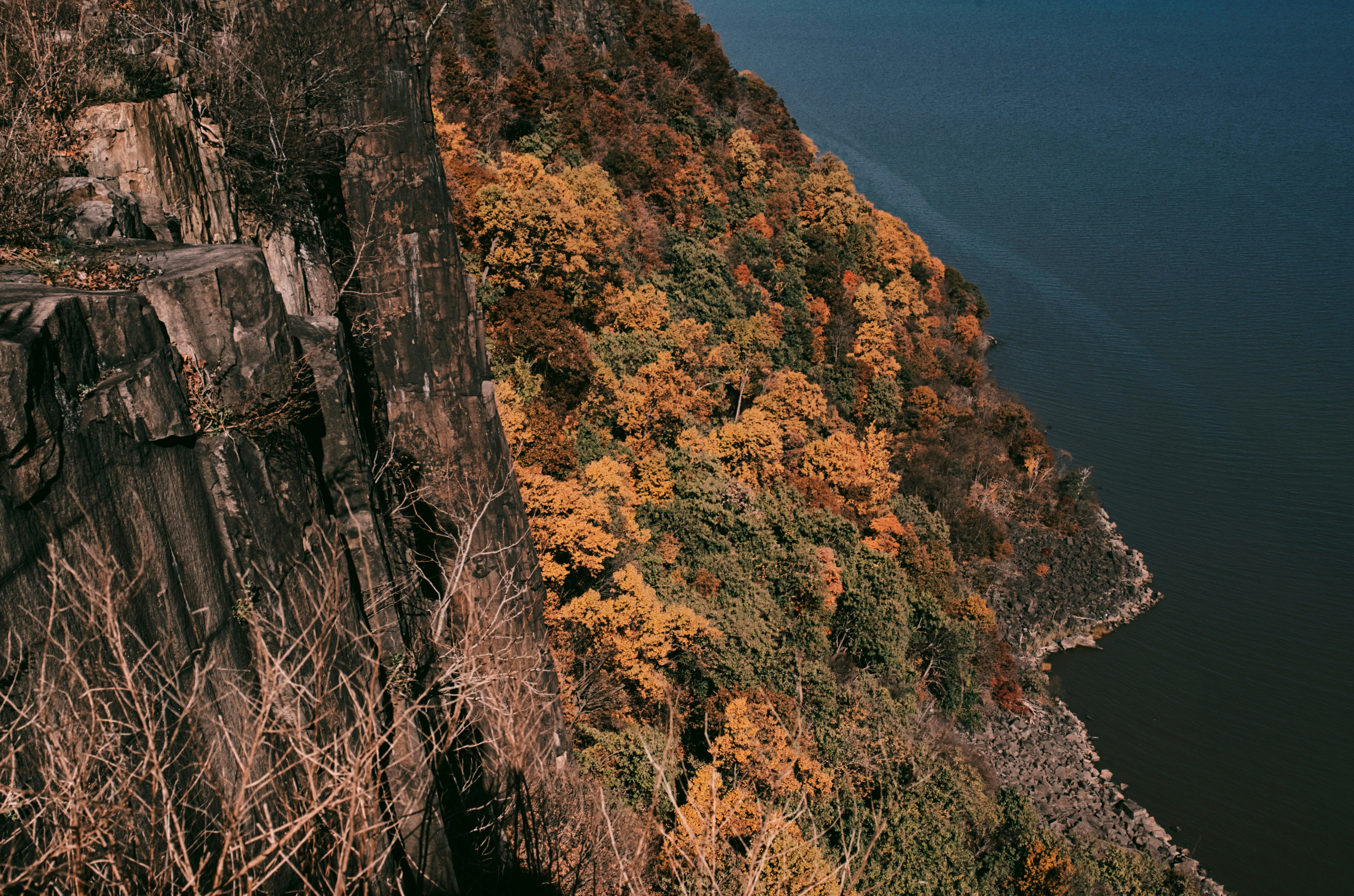 brown and green mountain beside blue sea during daytime, 