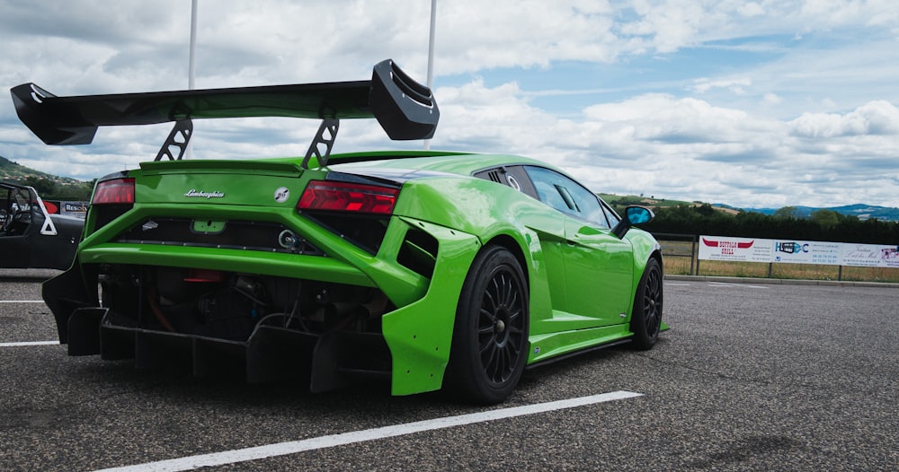 green and black sports car on road during daytime