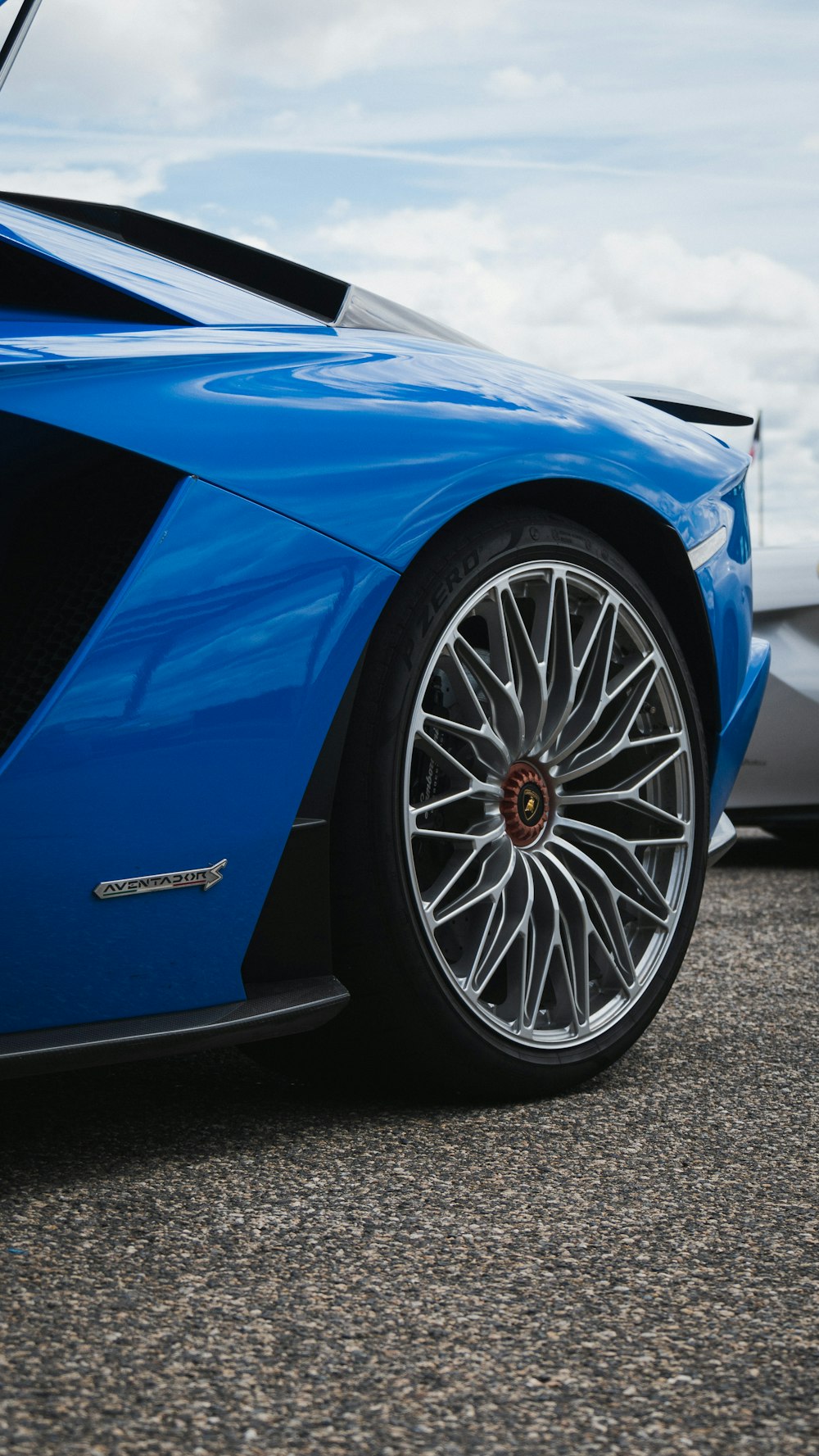 blue car on gray asphalt road