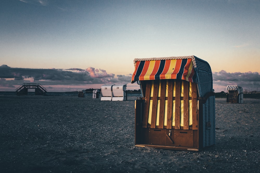 brown wooden shed on gray sand during daytime