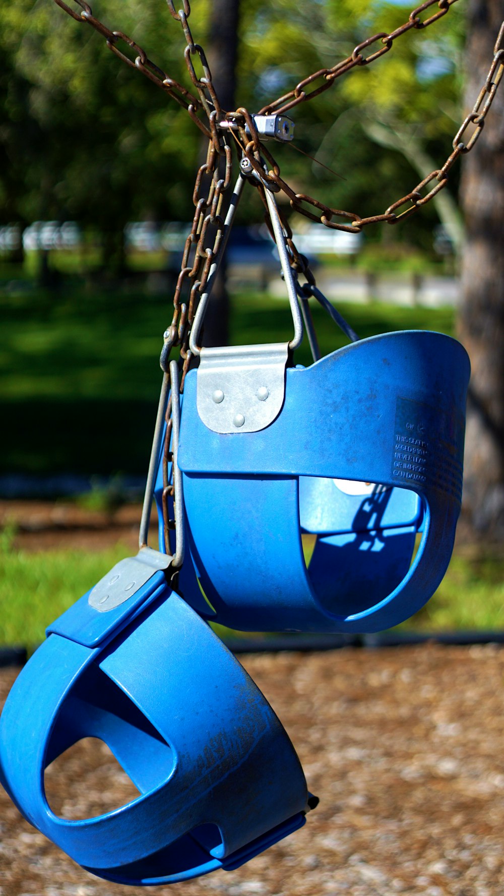 blue swing chair on green grass field during daytime