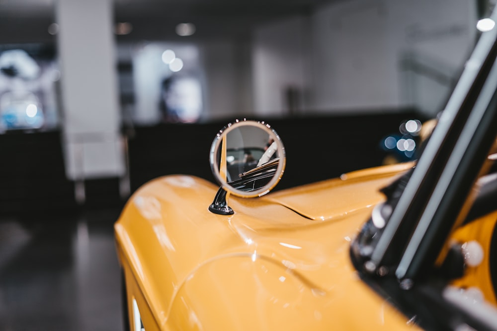 black and silver round watch on yellow car