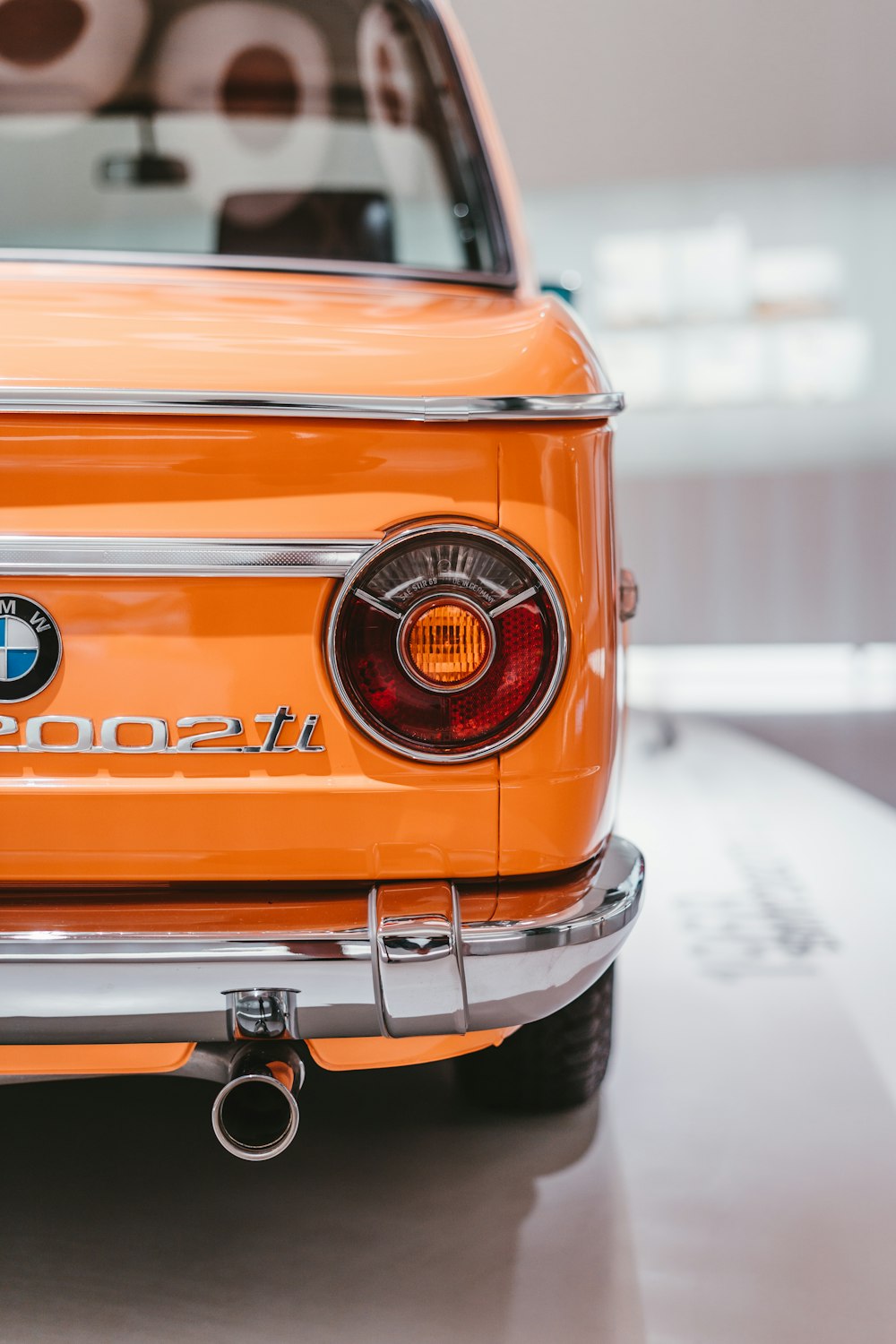 a close up of an orange bmw car
