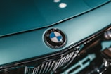 green bmw car in close up photography