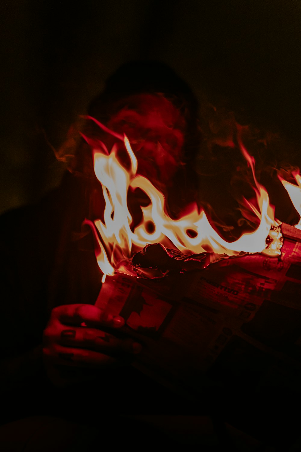 person holding red fire during nighttime