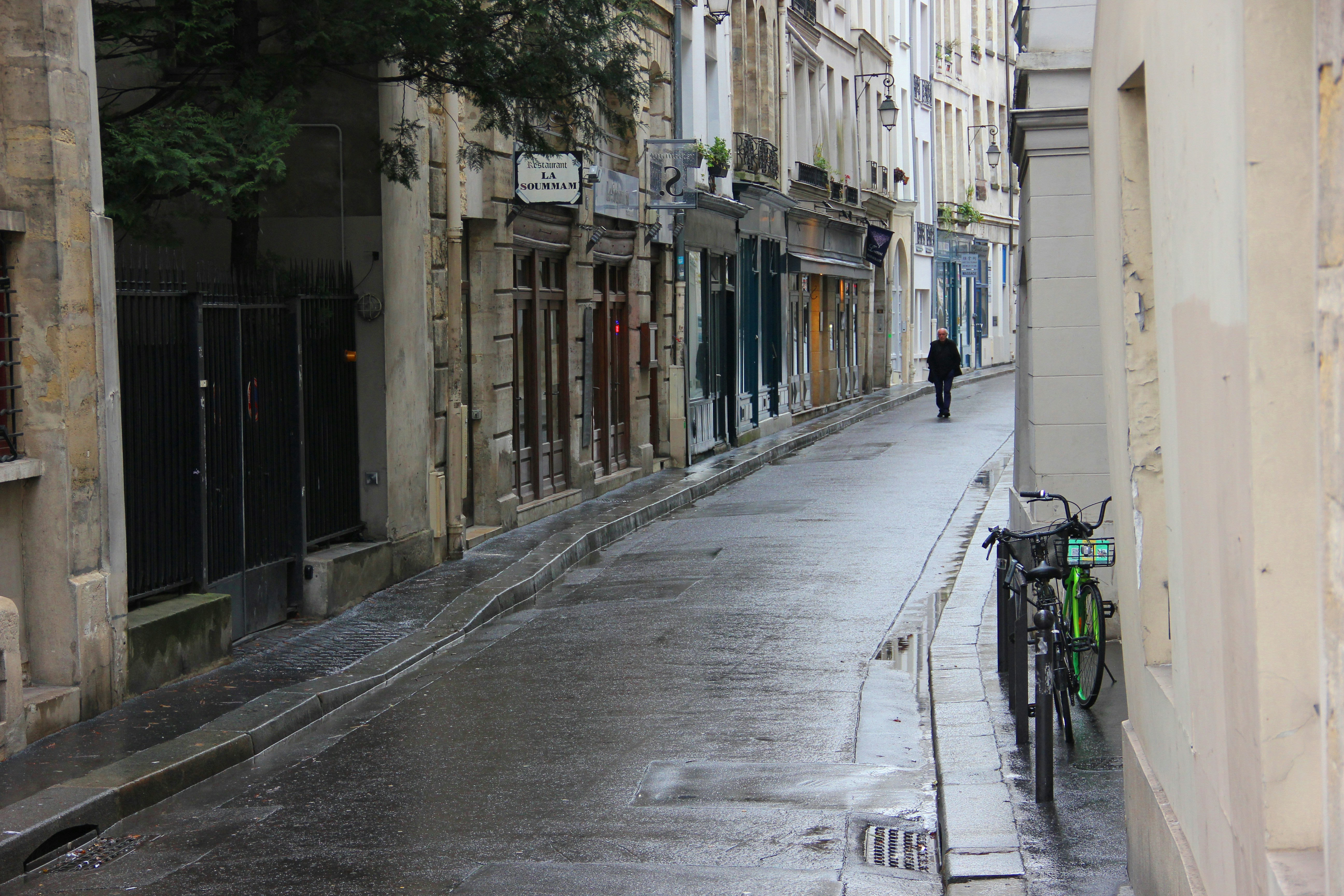 black bicycle parked on sidewalk during daytime, 