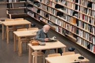 man in gray dress shirt sitting on chair