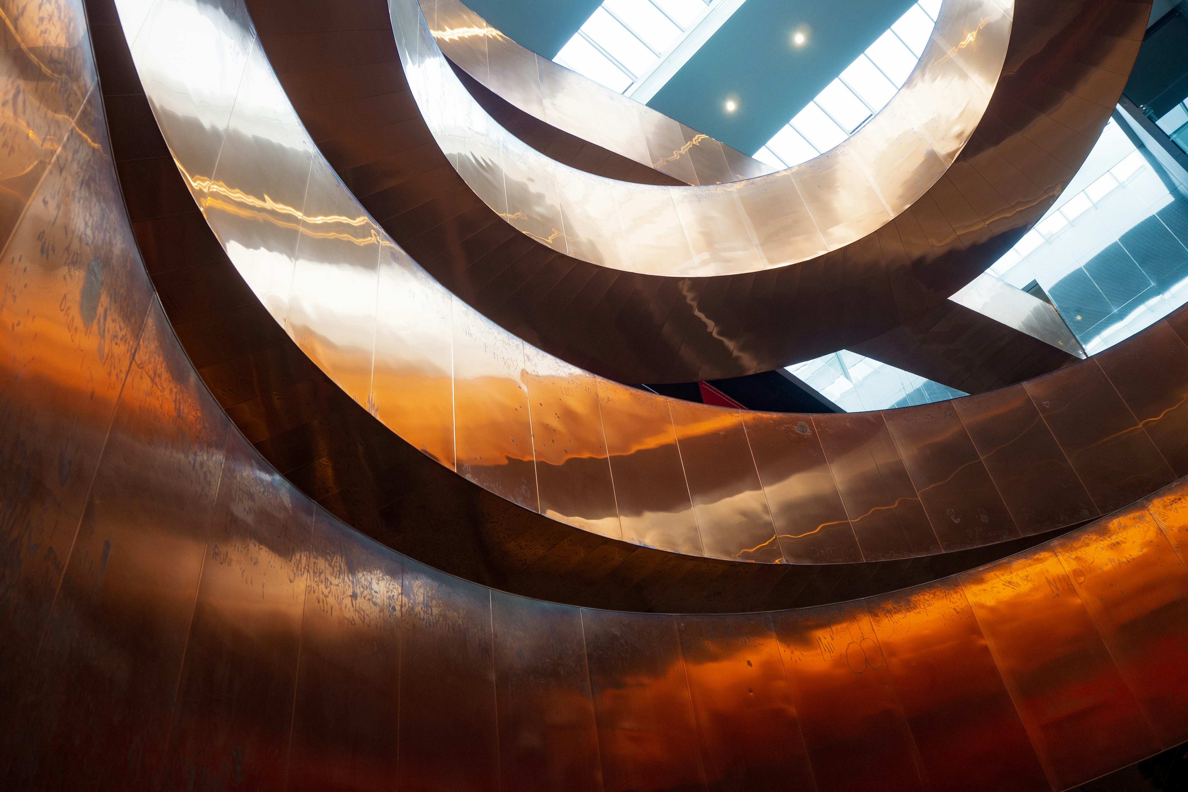 brown spiral staircase with glass windows