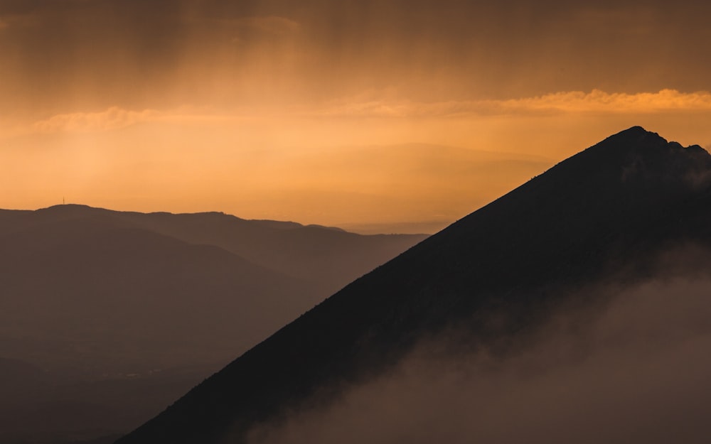 silhouette of mountains during sunset